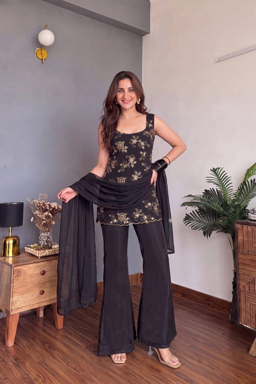 Woman wearing black georgette suit set with embroidered top, palazzo and dupatta