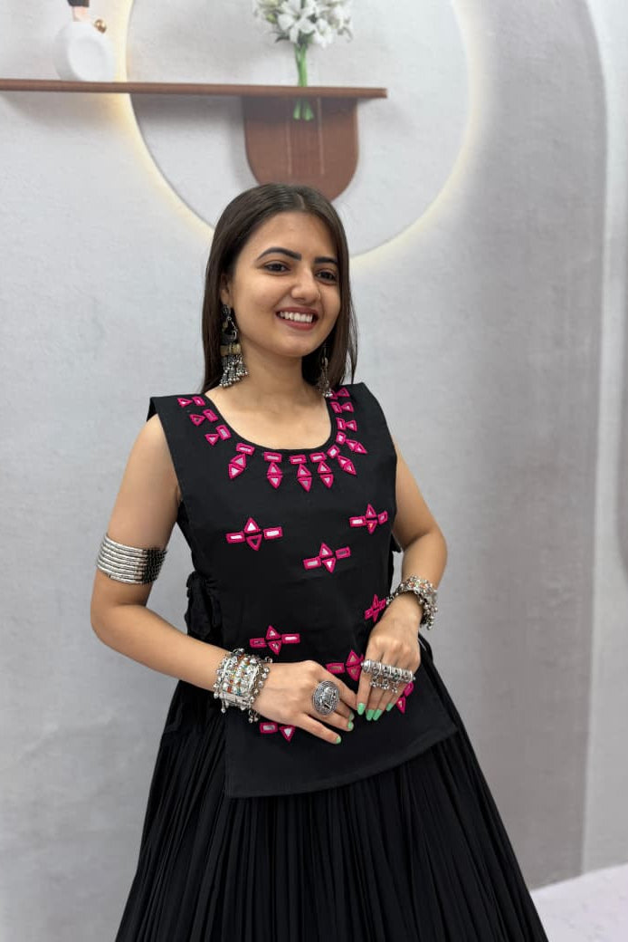 Close-up of black Navratri Chaniya Choli showing pink decorative motifs and neckline detailing