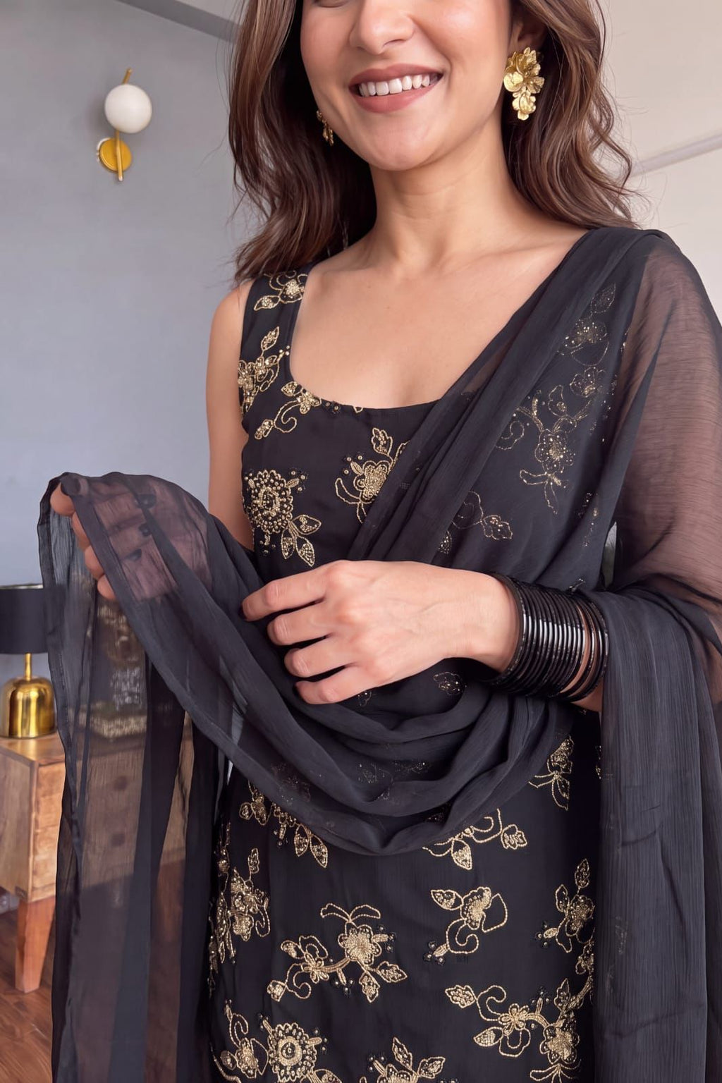 Women's black party wear suit with embroidered top and flared palazzo