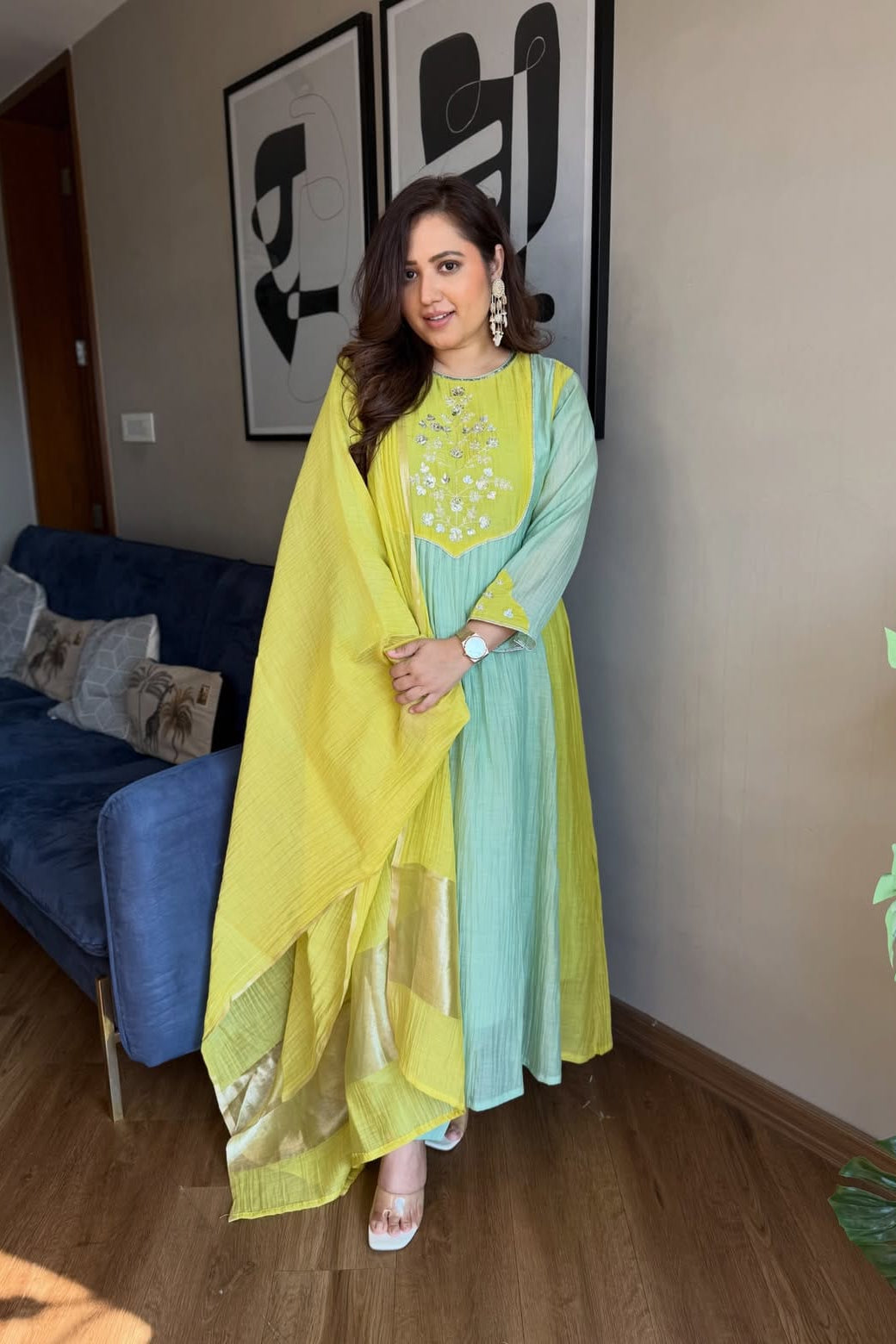 Model wearing a flared Chanderi suit set with contrasting aqua and lime green tones