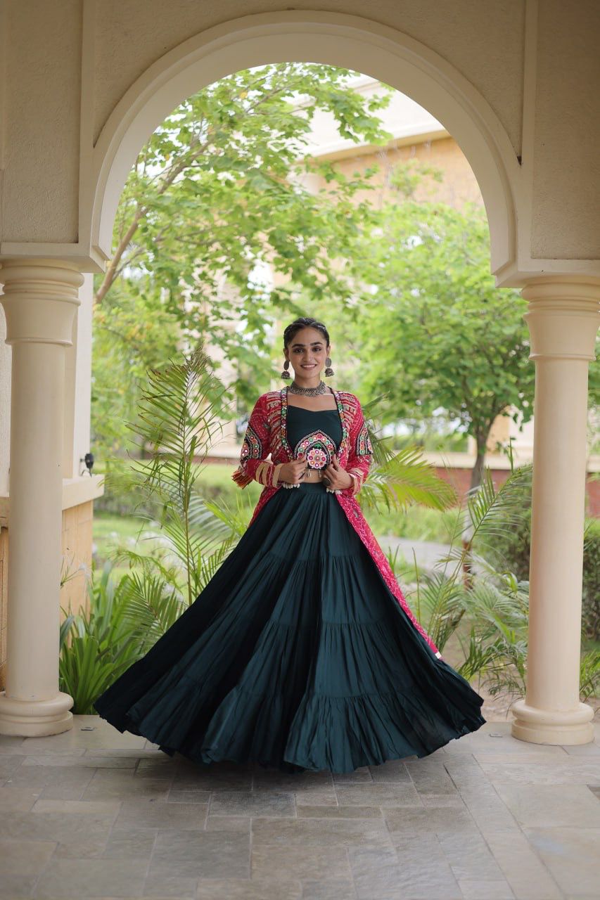Dark teal rayon lehenga paired with a pink printed shrug for a vibrant Navratri outfit
