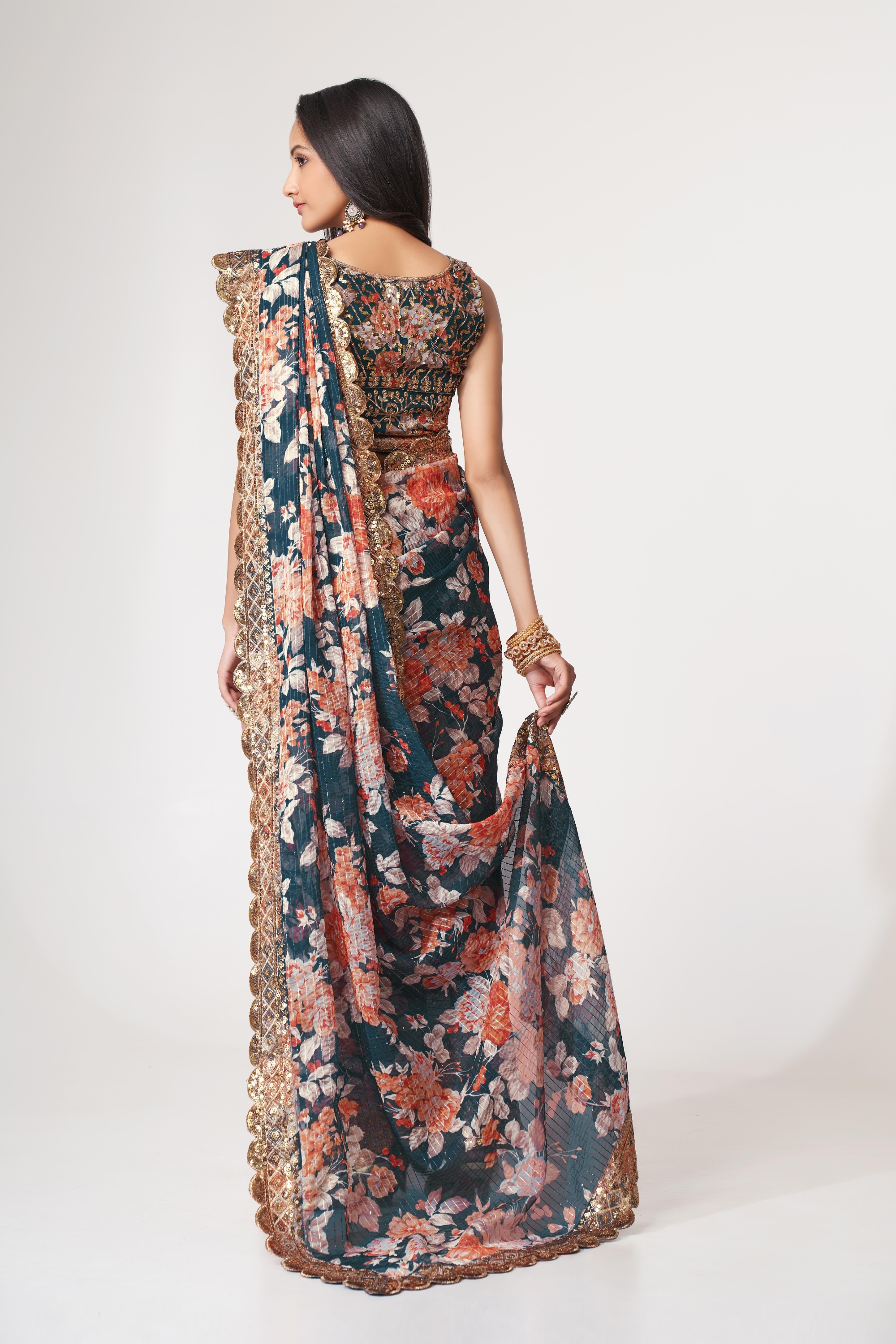 Back view of a deep teal floral organza saree showing the printed pallu and embellished blouse design