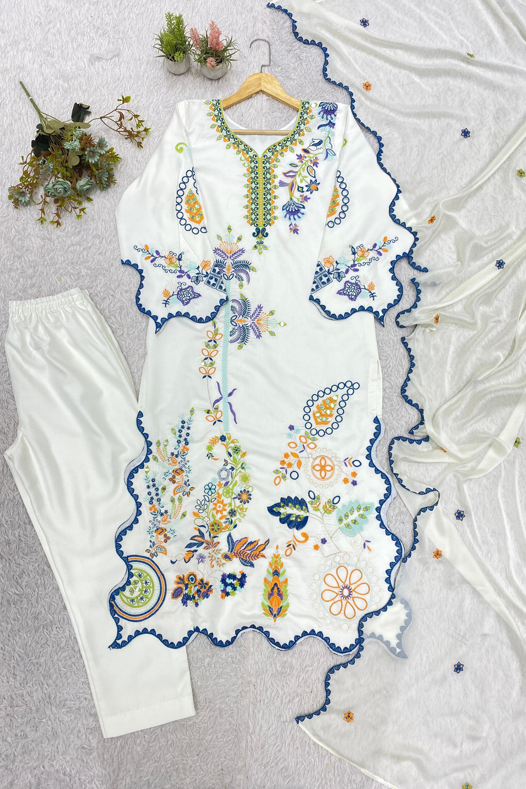 Embroidered Pakistani kurta set featuring mirror work and colorful floral motifs