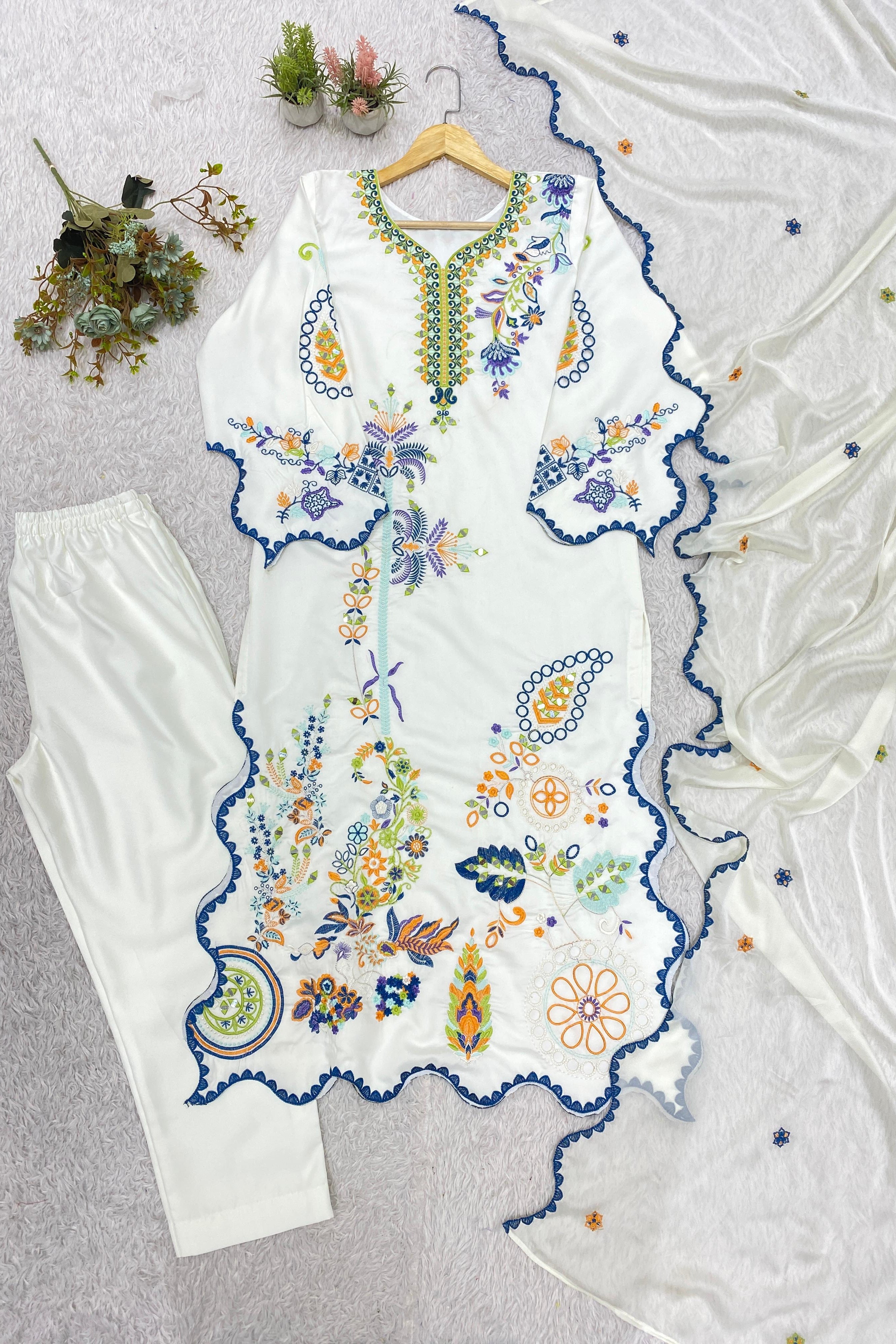 Embroidered Pakistani kurta set featuring mirror work and colorful floral motifs