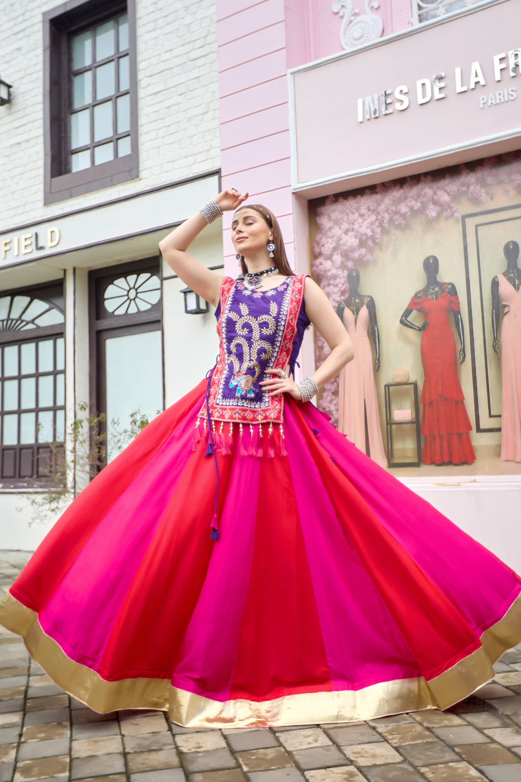 Flared Indian lehenga with vibrant pink red panels and gold Lampi Lace border