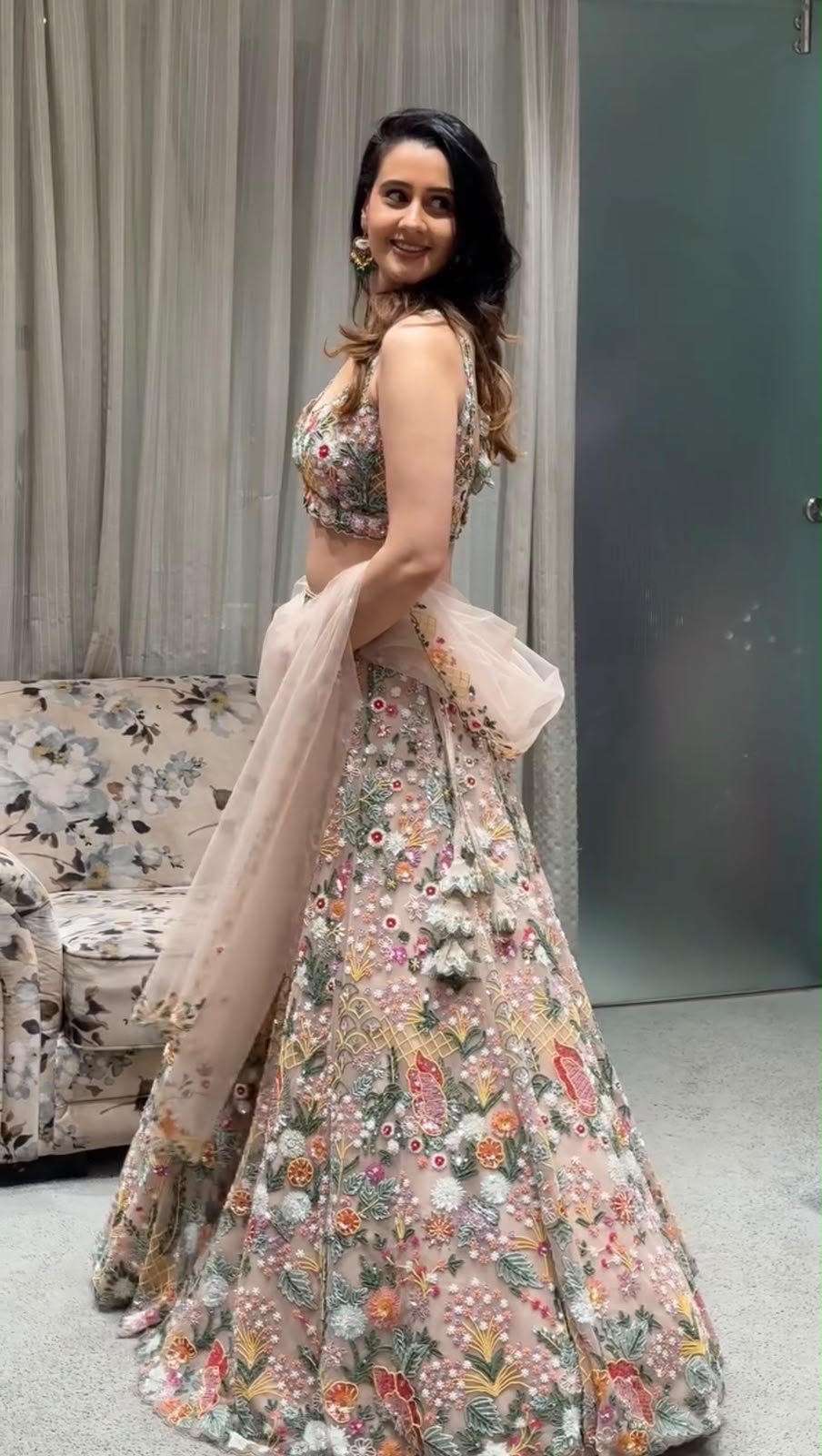 Floral lehenga choli back view showing the detailed worked blouse and flowing dupatta