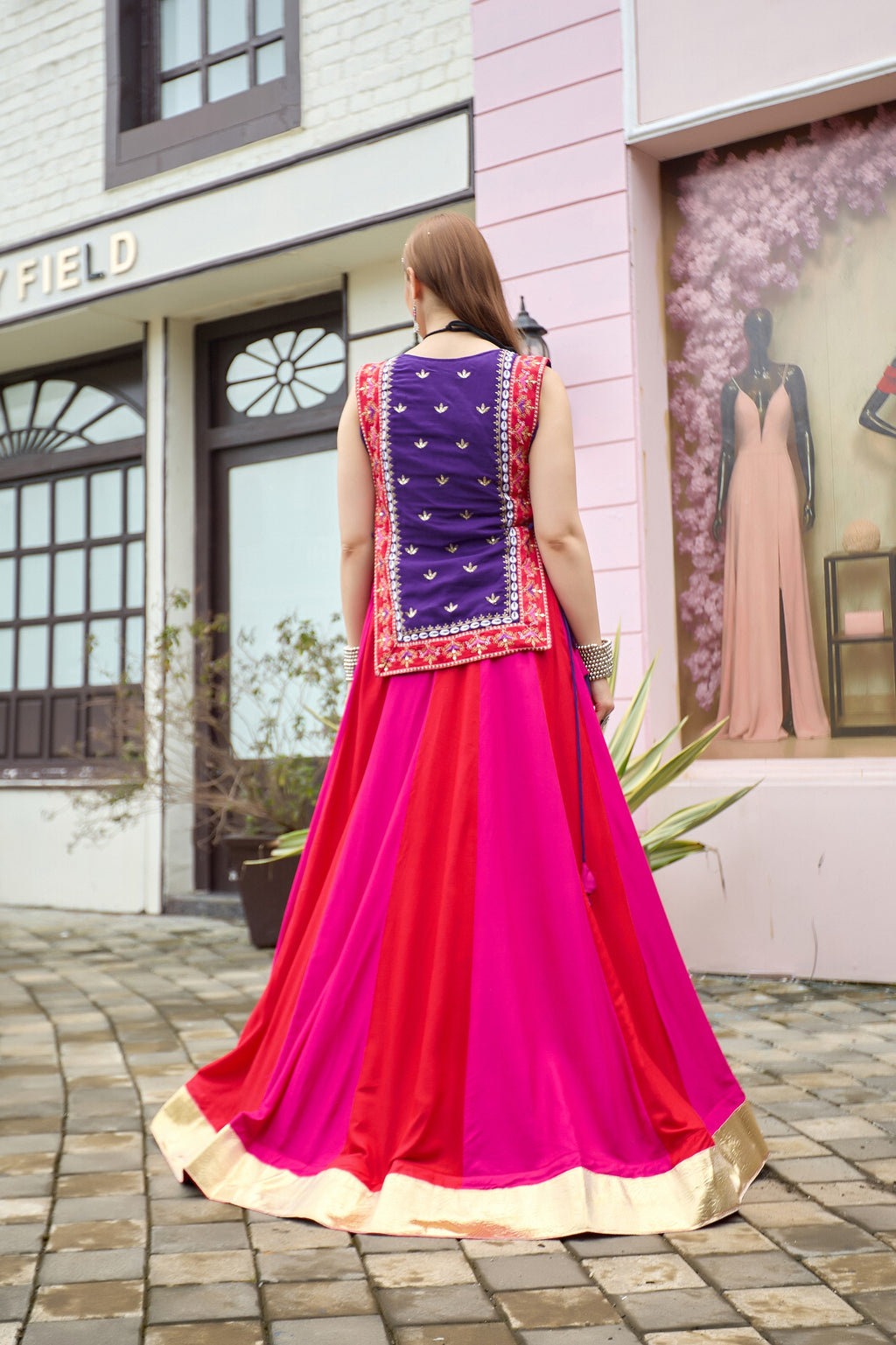 Back view of purple pink Indian lehenga choli with detailed shrug and flared skirt