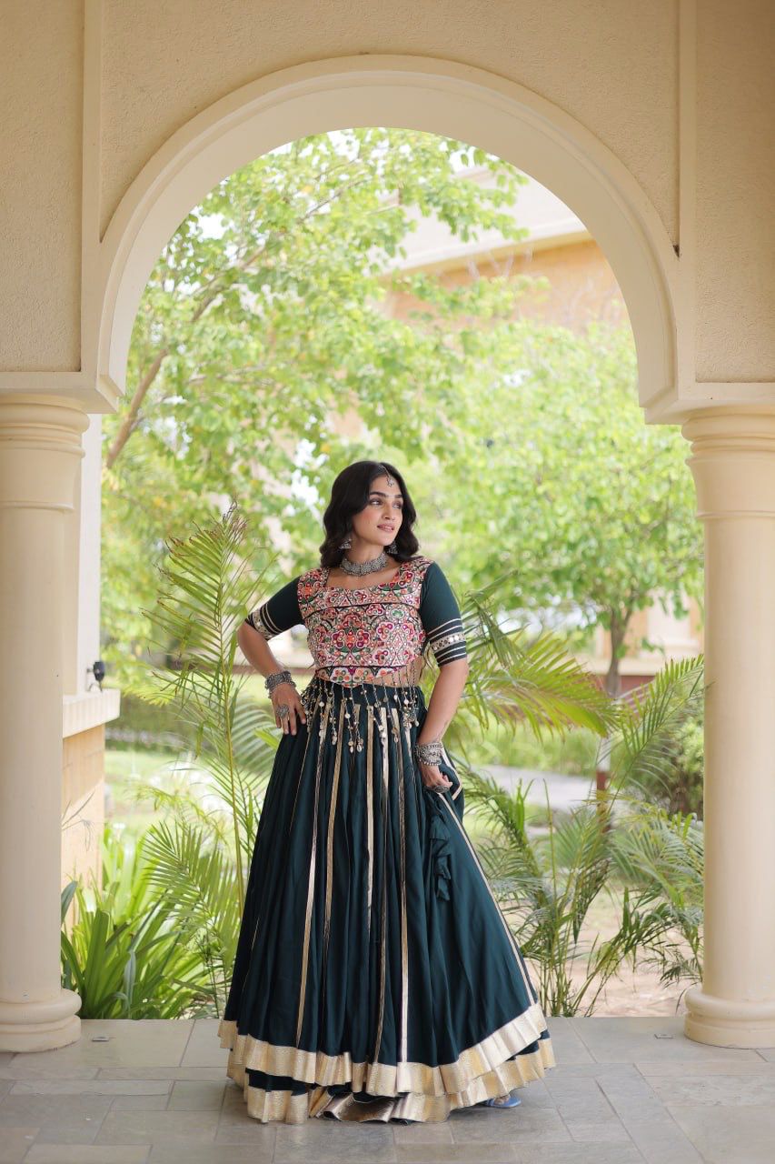 Indian lehenga choli featuring Gamthi embroidery, mirror work and flowing green skirt