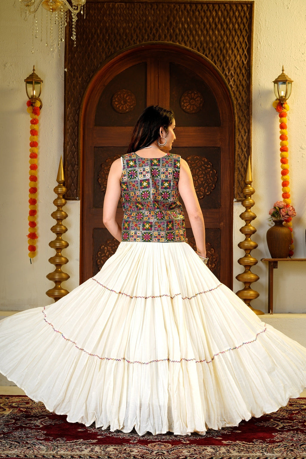 9 meter Indian lehenga choli set shown from the back with a colorful embroidered shrug