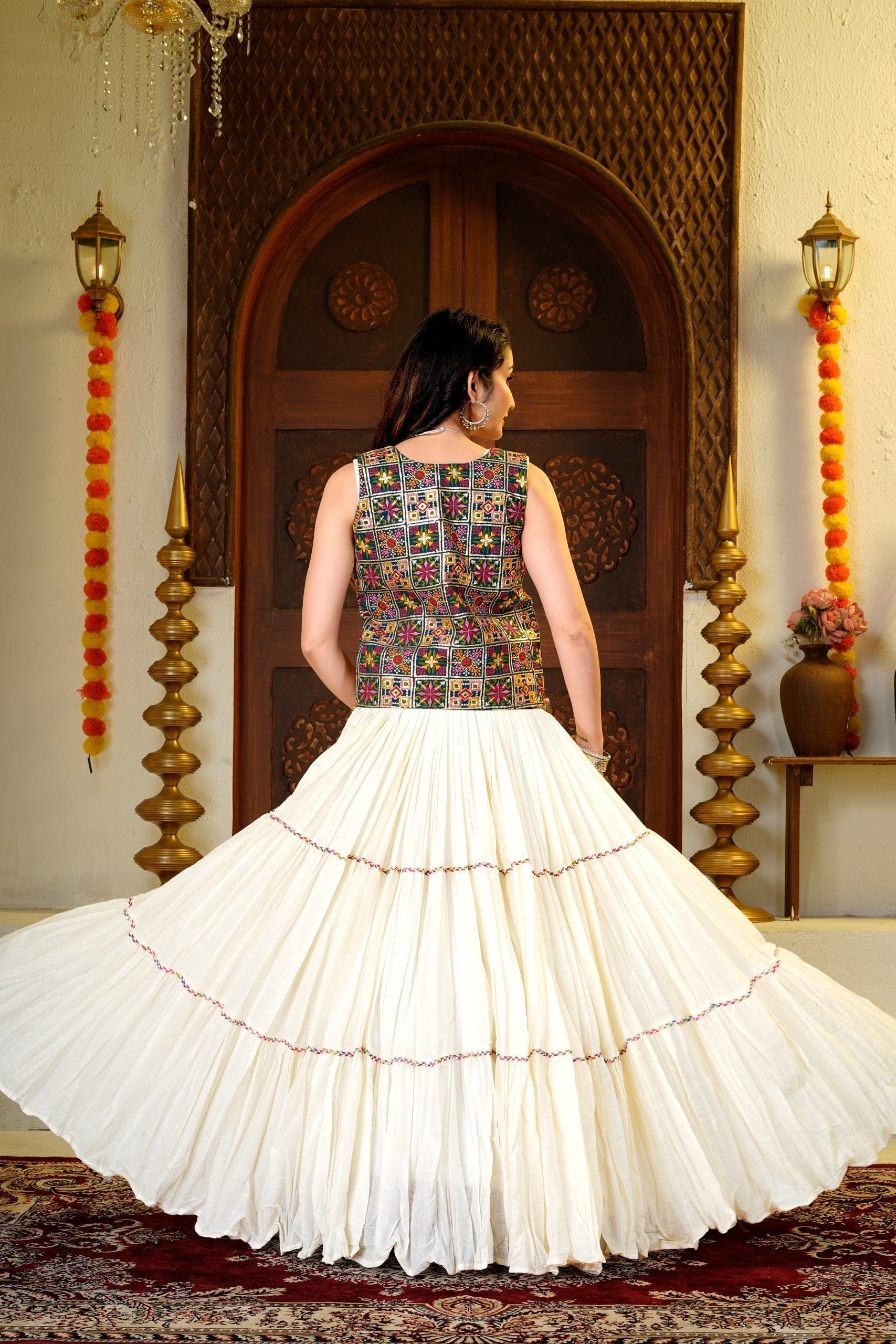 9 meter Indian lehenga choli set shown from the back with a colorful embroidered shrug