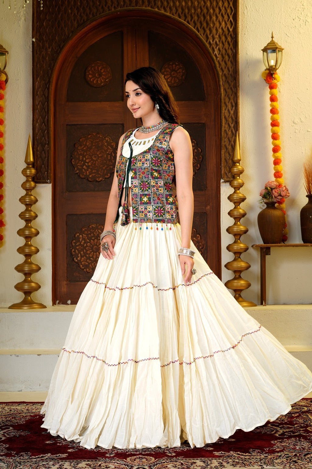 Side view of Indian lehenga choli with embroidered shrug and layered flared skirt