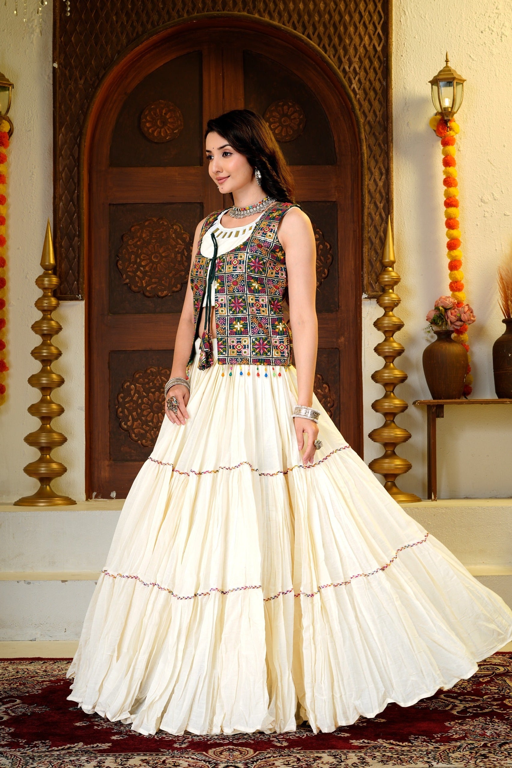 Side view of Indian lehenga choli with embroidered shrug and layered flared skirt