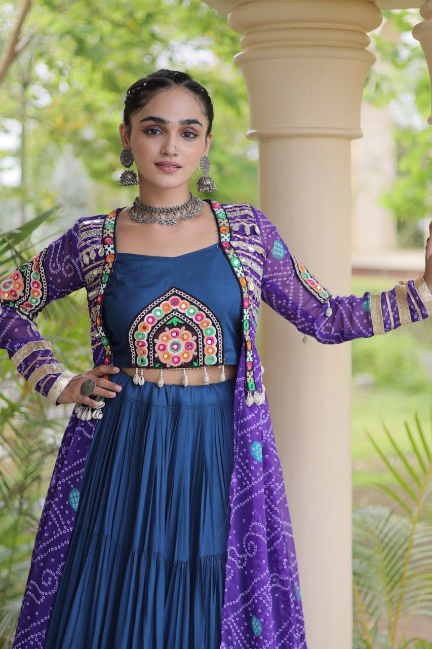 Close-up of a navy blue blouse with colorful Kutchi patchwork and purple printed shrug for Navratri celebrations