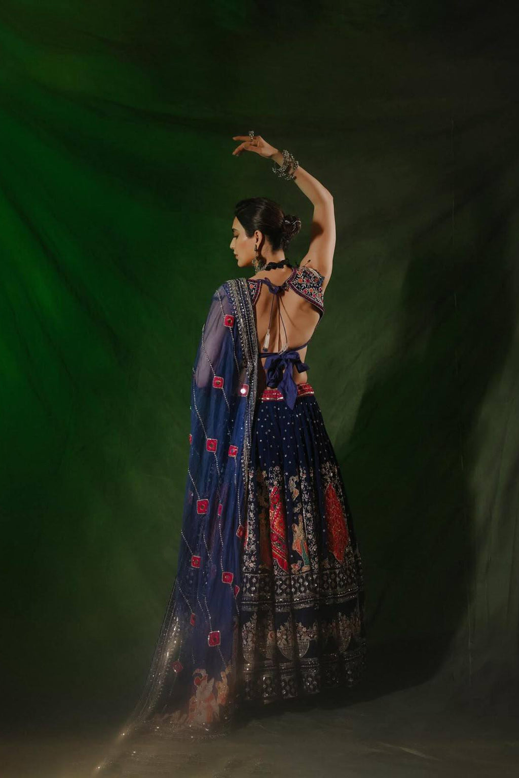 Back view of navy blue Chaniya Choli showing the open-back blouse styling and detailed dupatta