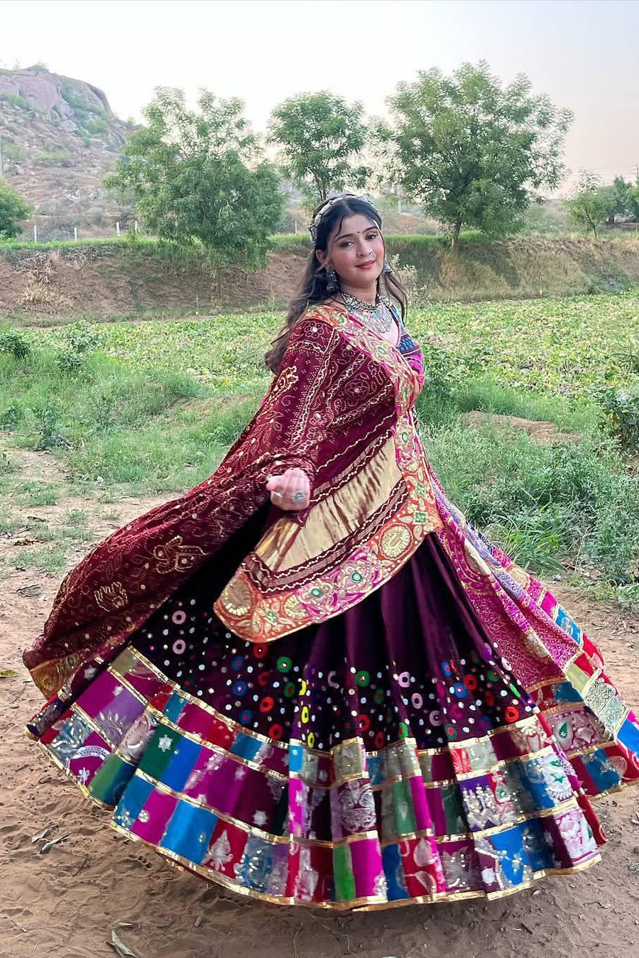 Maroon Navratri Chaniya Choli with colorful mirror work styled for a festive Garba look