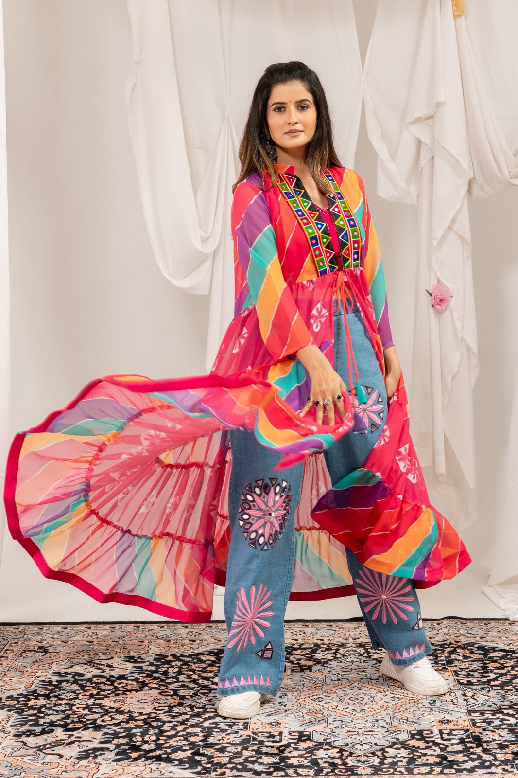 Woman wearing a vibrant Navratri denim outfit with flowing faux georgette shrug