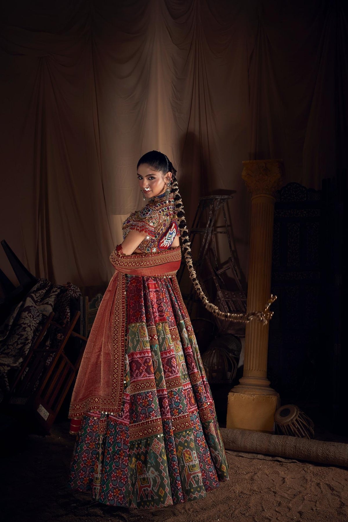 Navratri lehenga choli styled with detailed dupatta, mirror work and multicolour handwork lace
