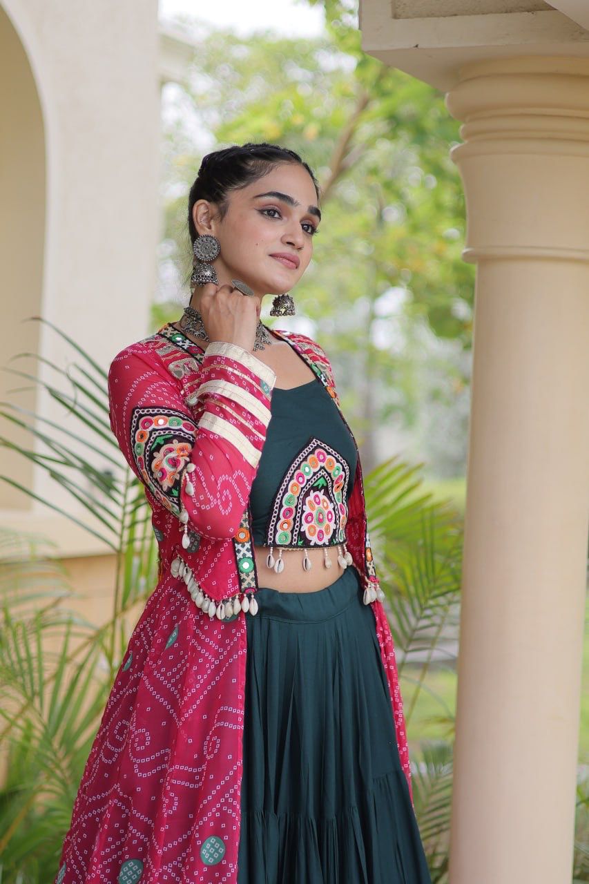 Navratri lehenga choli featuring a dark teal frill skirt and pink Kutchi patchwork shrug