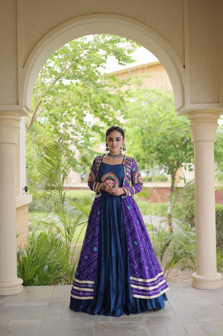 Purple Navratri lehenga choli with Kutchi patchwork shrug shown from the back in an elegant outdoor setting