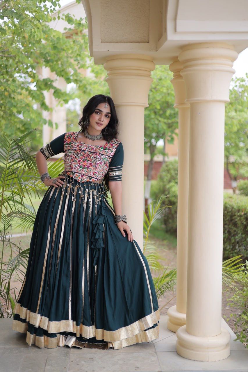 Navratri lehenga choli in deep green with ornate embroidery and flowing skirt