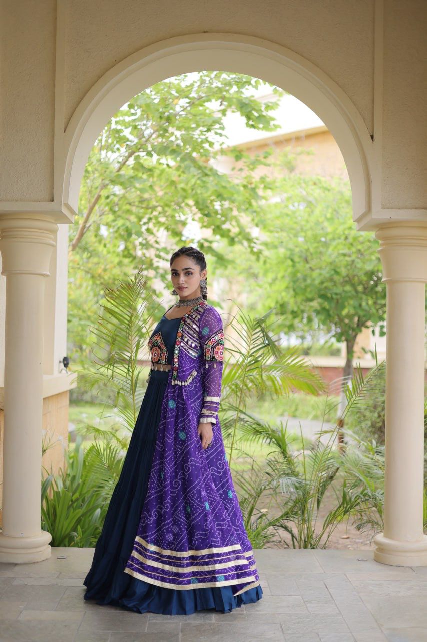Side view of a purple Navratri lehenga choli featuring a printed shrug, colorful patchwork and flowing skirt