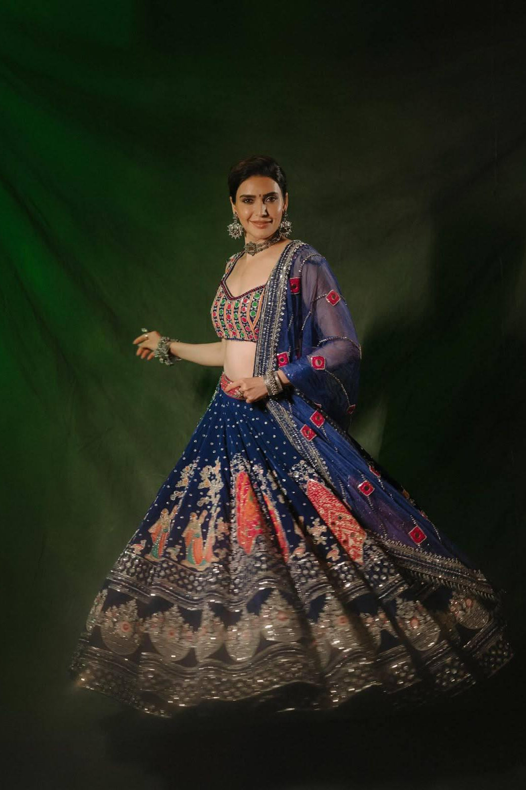 Navy blue Navratri lehenga choli twirl showing the detailed flared skirt and embellished border