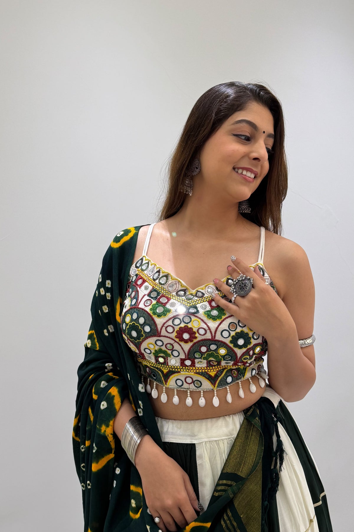 Detailed view of colorful mirror embroidery on a Navratri lehenga choli blouse