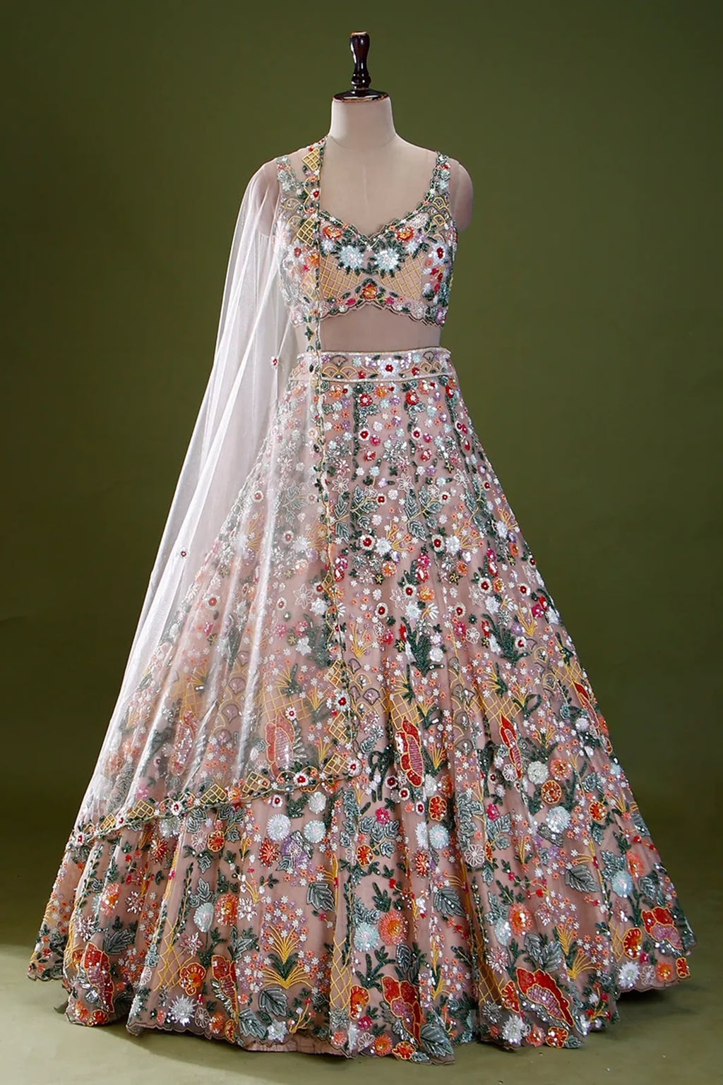 Pastel floral sequin lehenga choli styled with a sheer matching dupatta
