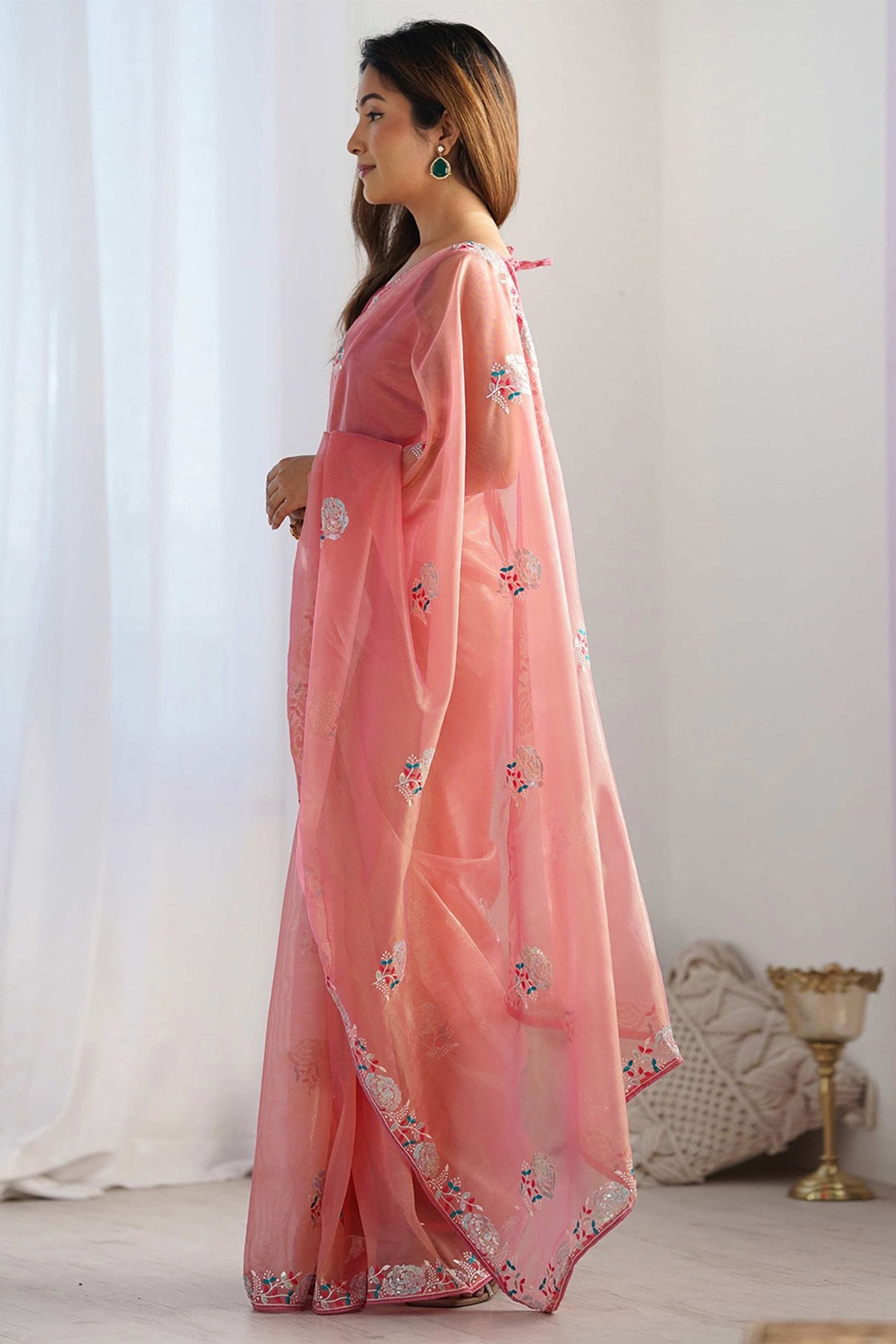 Peach Indian saree with delicate embroidery styled for festive and wedding occasions