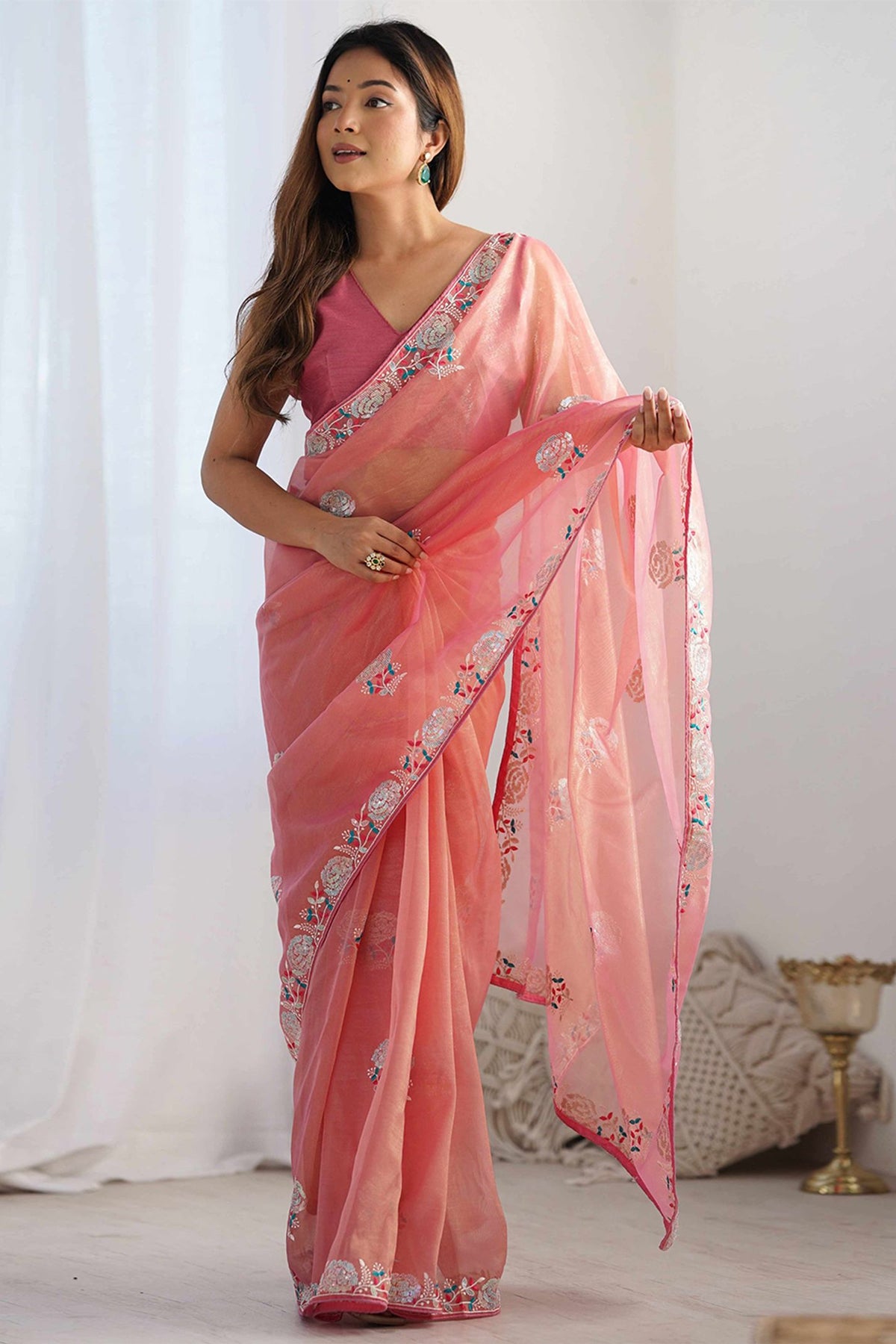 Peach wedding saree with embroidered border and elegant floral detailing
