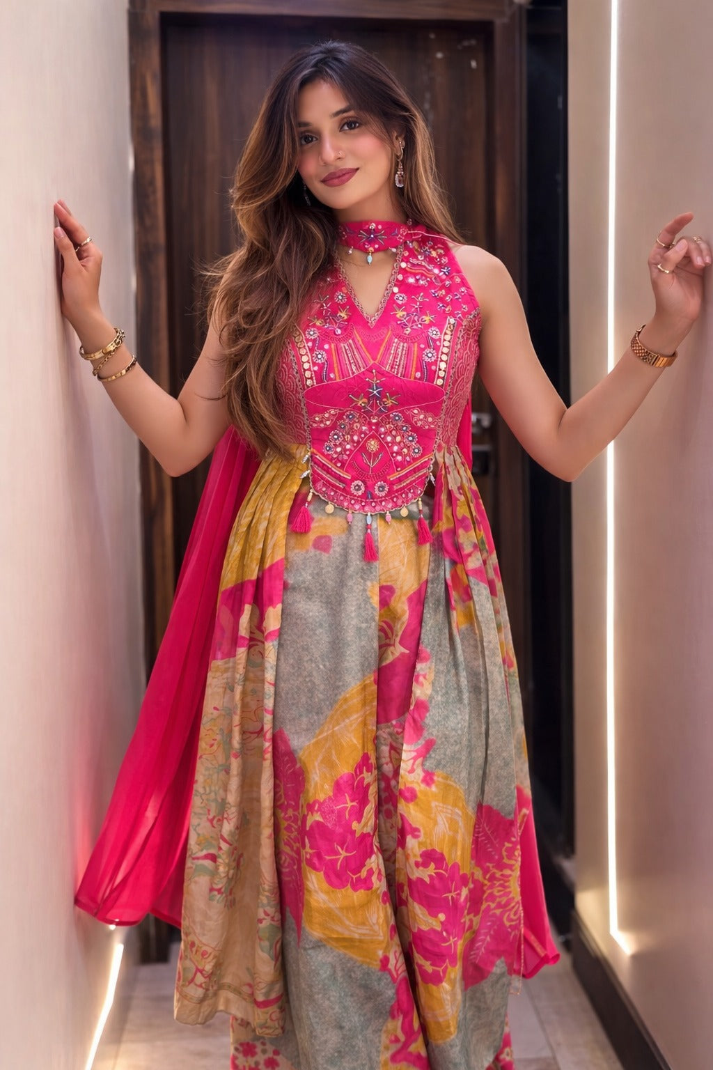 Close view of pink Chinon suit featuring intricate hand-work detailing and traditional motifs