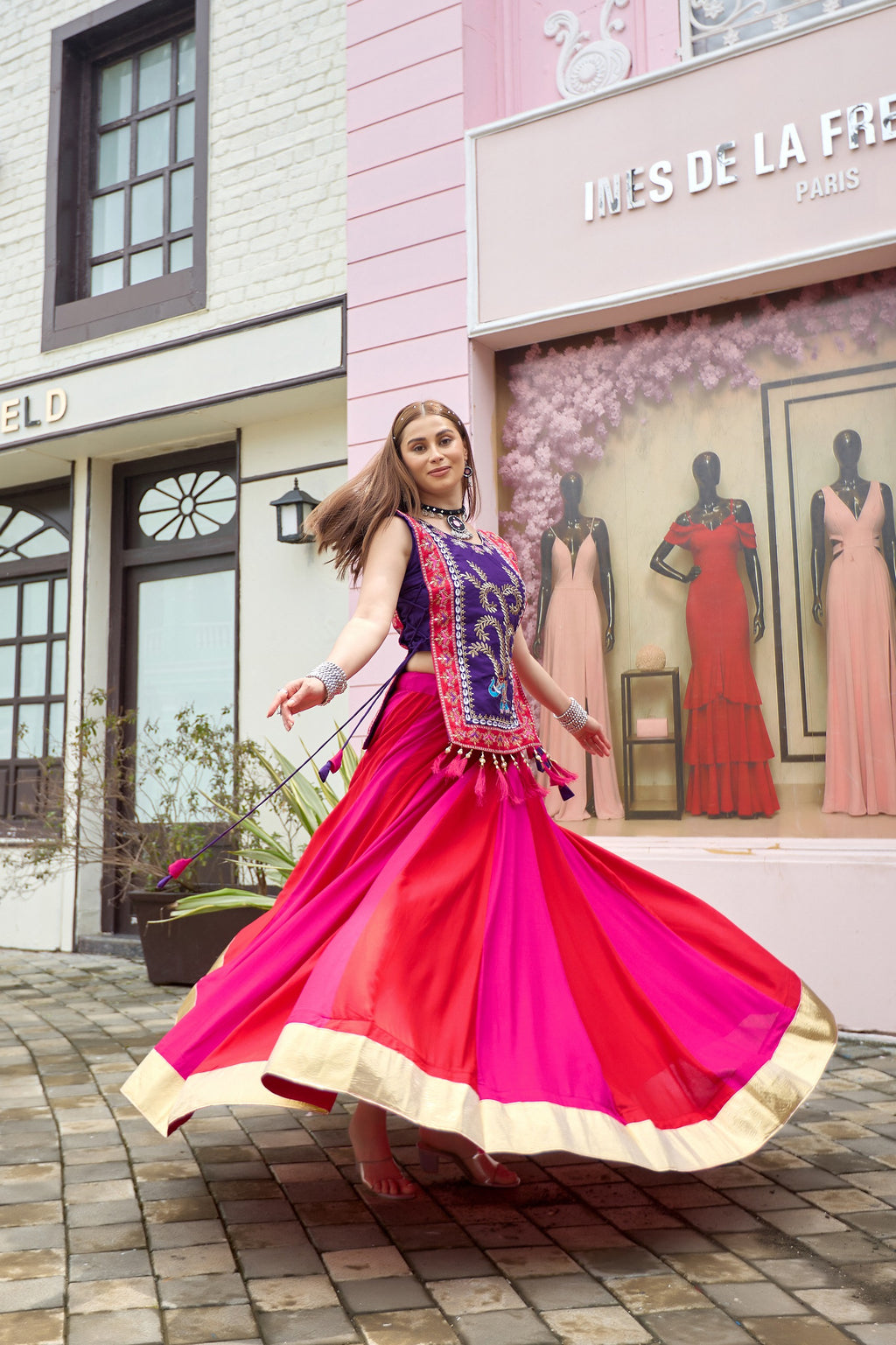 Pink and red Indian lehenga with embroidered purple shrug styled for festive wear