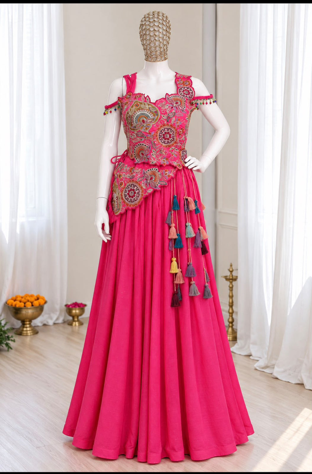 Stitched pink lehenga choli styled on a model with a flared skirt and embroidered blouse