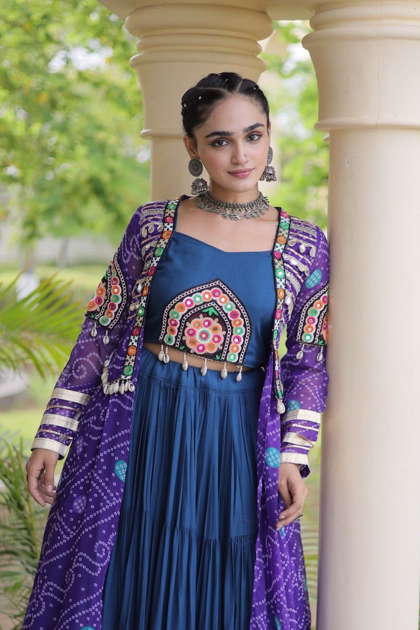 Model wearing a purple Kutchi patchwork shrug with navy blue lehenga choli and detailed festive blouse