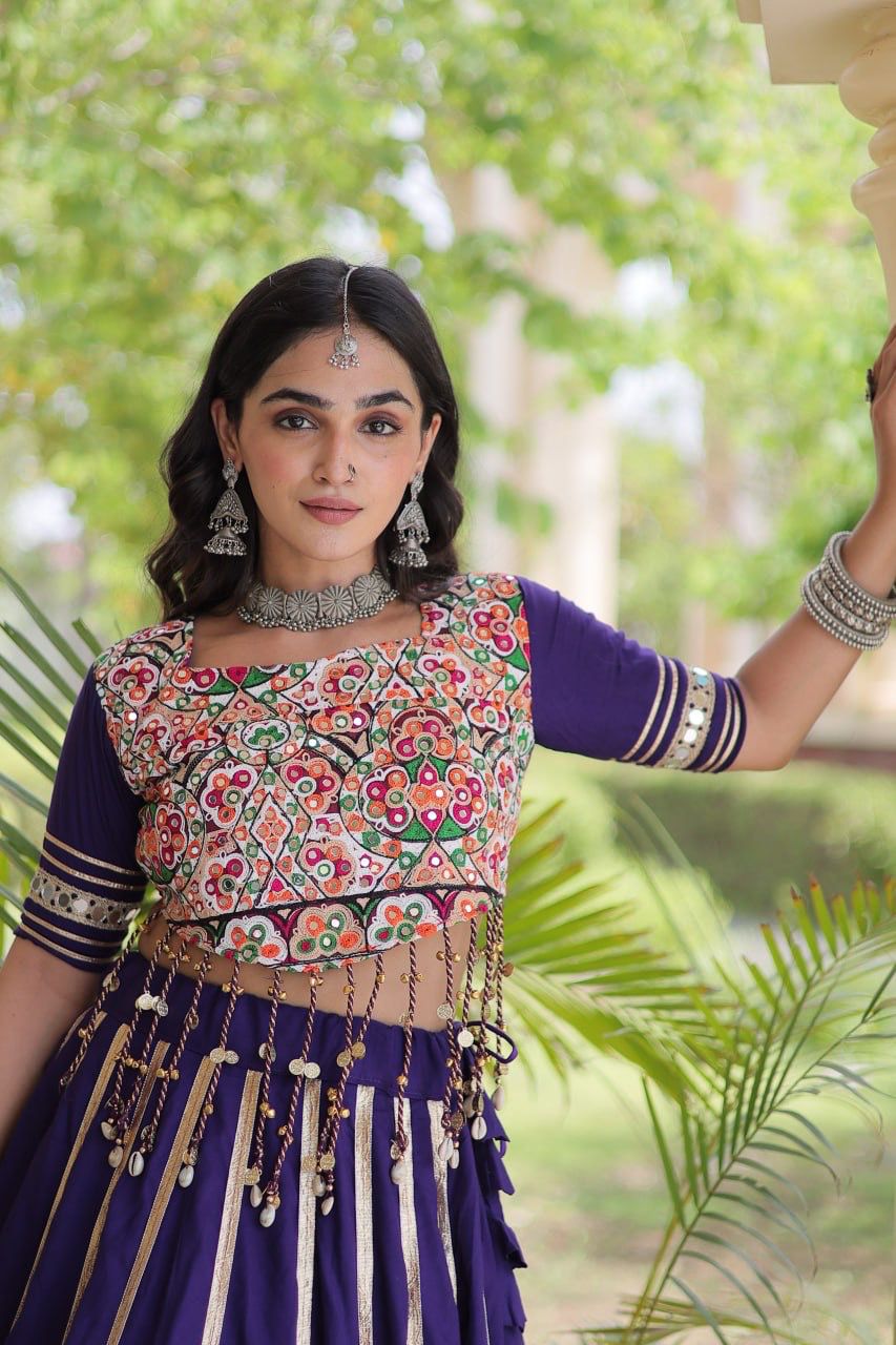Detailed view of purple lehenga choli with embroidered blouse and decorative waist accents