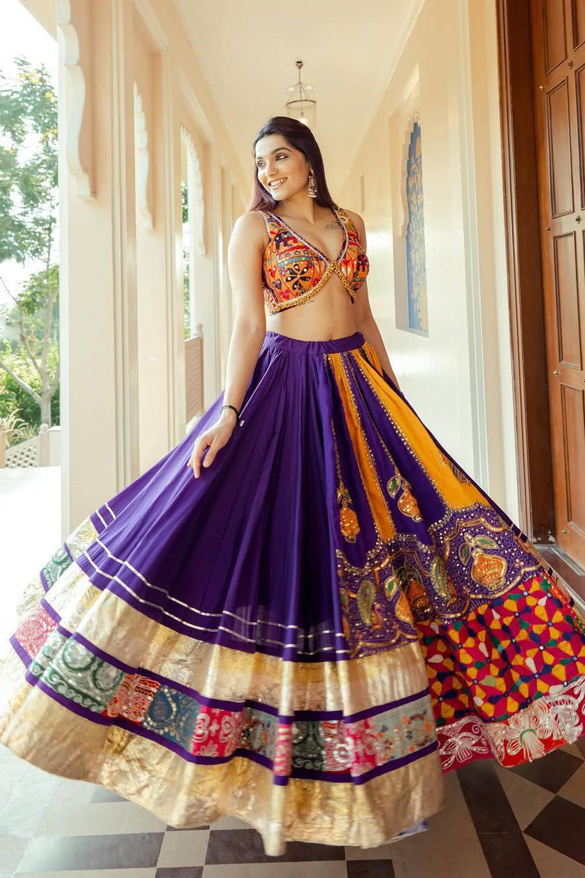 Flared purple Navratri lehenga with orange printed panels, mirror work and decorative border