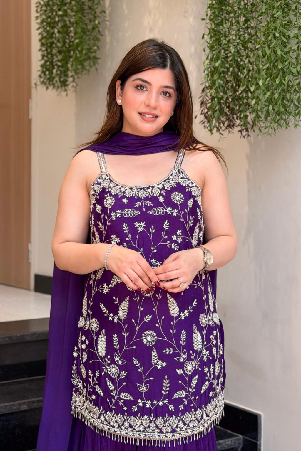 Close-up of purple Indian palazzo suit showing floral embroidery and sequin detailing