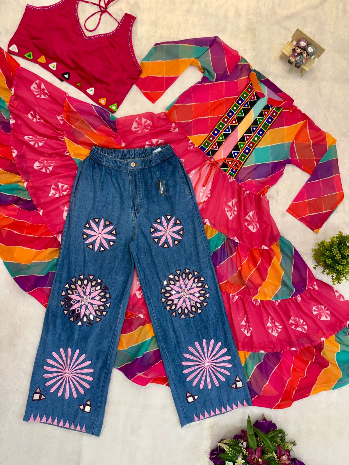 Woman styling Rang Denim Navratri outfit with embroidered jeans and colorful long shrug