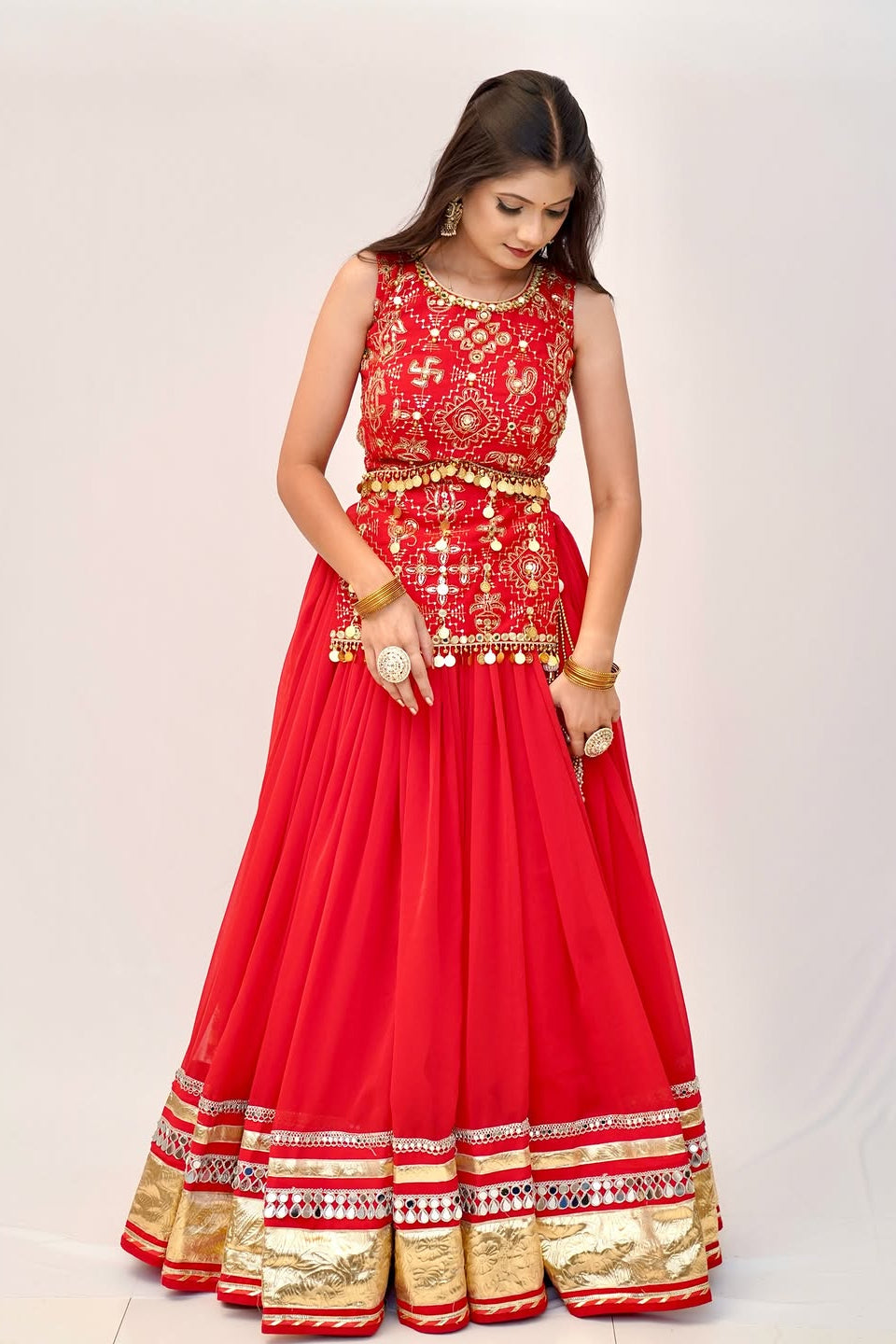 Red lehenga choli front view featuring embroidered choli and traditional gold detailing