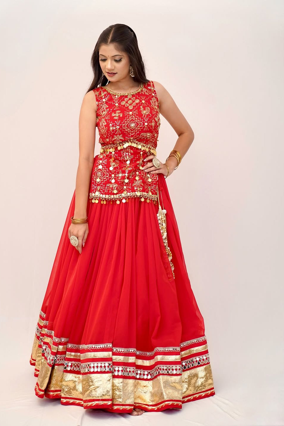 Red embroidered lehenga choli front view with traditional motifs and gold-toned lace work