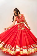 Side-back view of red lehenga choli showing the choli tie-up and flowing skirt