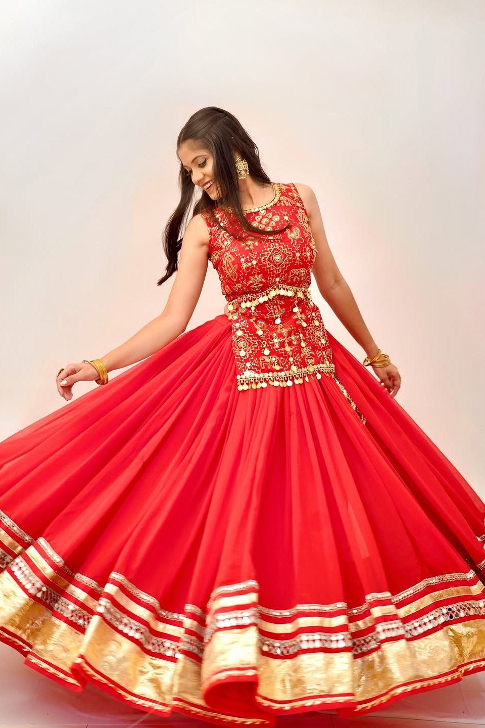 Side-back view of red lehenga choli showing the choli tie-up and flowing skirt