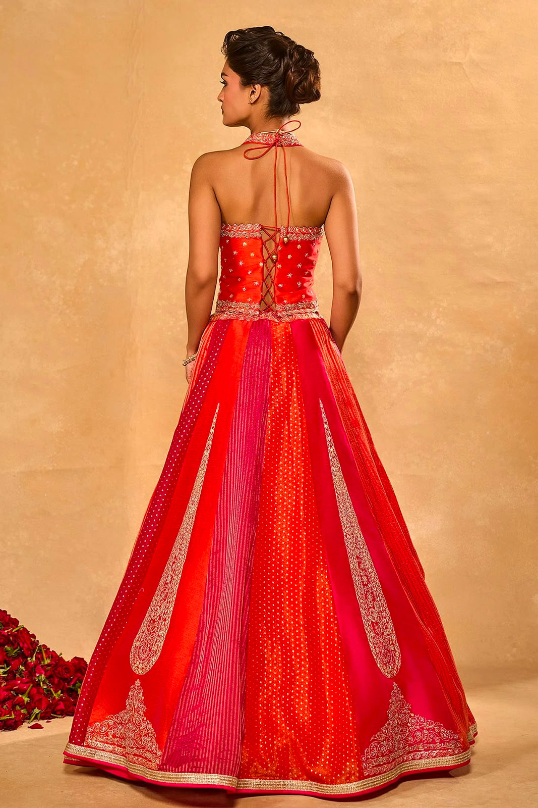 Back view of the red pink stitched lehenga choli showing the lace-up blouse and detailed skirt