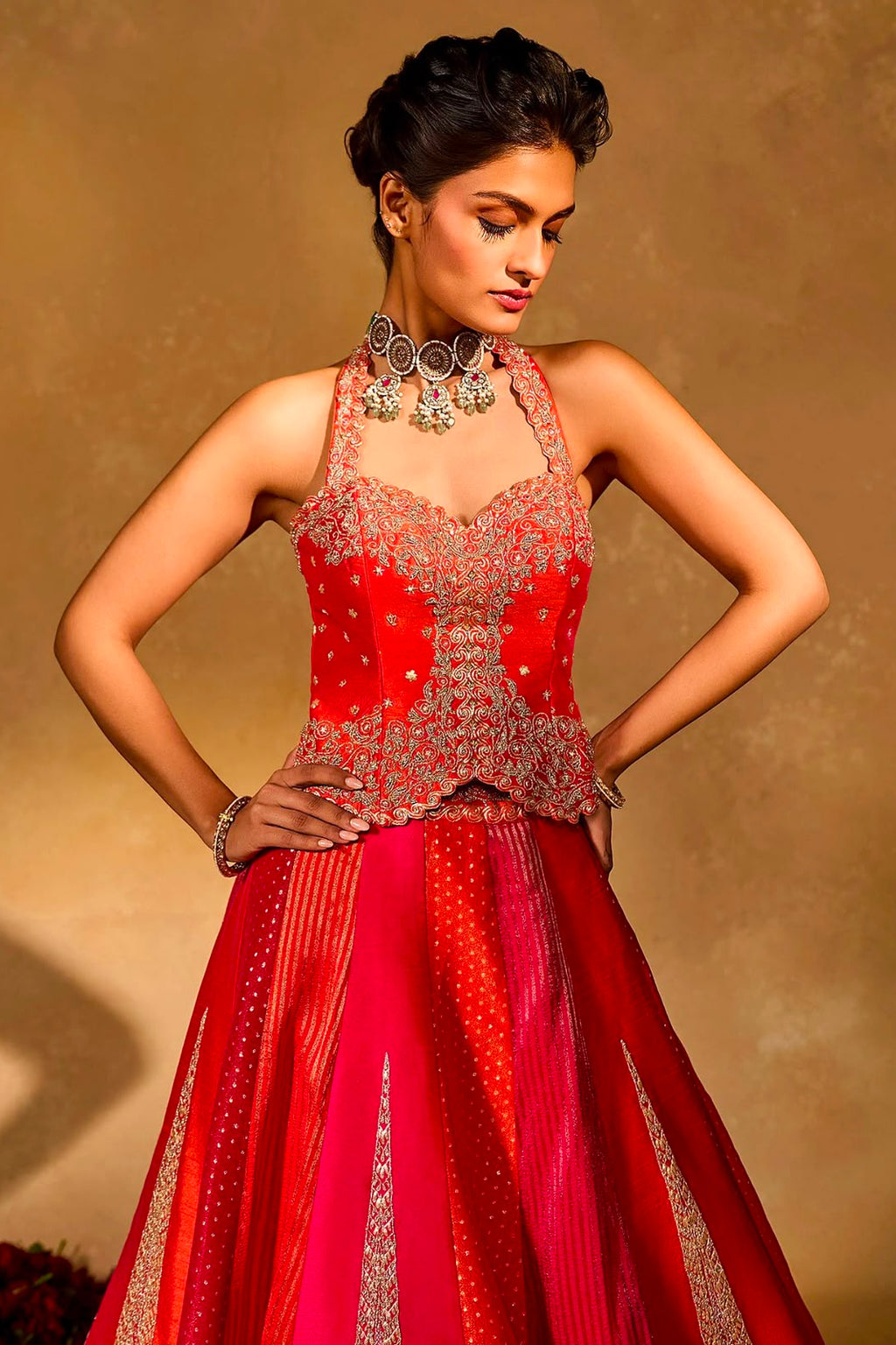 Red pink sequin embroidered lehenga choli with halter-style stitched blouse and flowing skirt