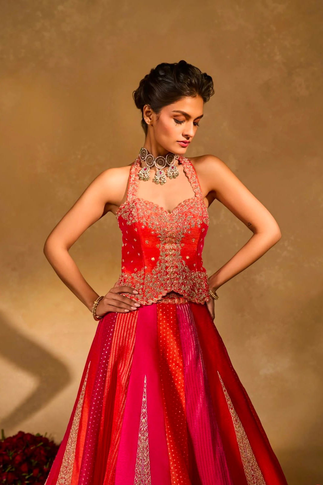 Front view of a red pink stitched lehenga choli with embroidered blouse and flowing 4-meter flair