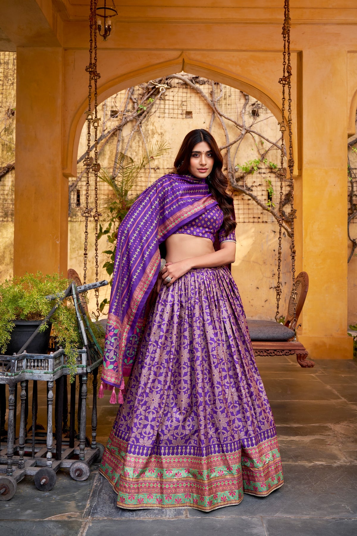 Red Tasar Silk Lehenga Choli with sparkle work, lace border and tassel dupatta in a festive setting