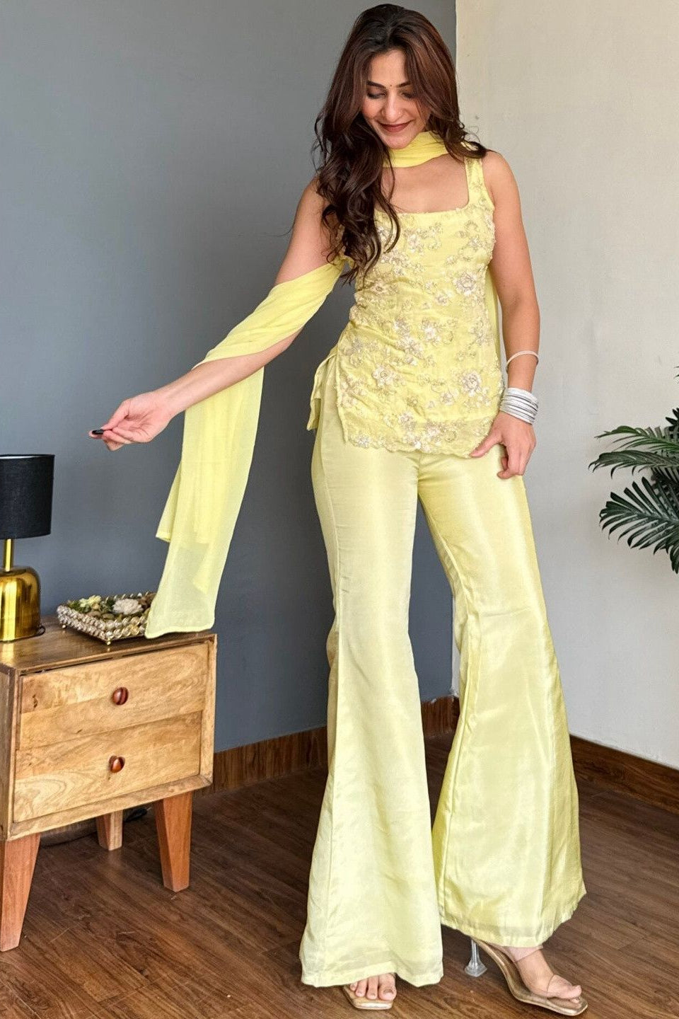 Women's yellow party wear suit set with embroidered top and flared palazzo